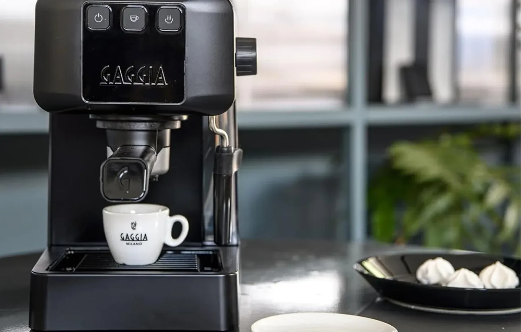 Cafetera Gaggia instalada en la cocineta de una oficina, sirviendo un espresso